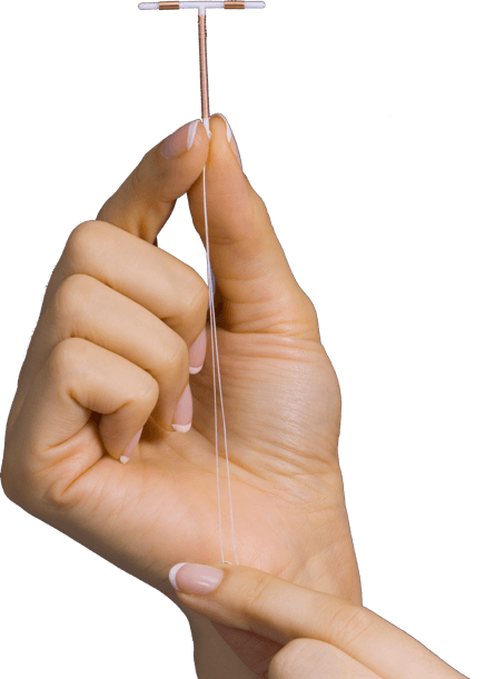 Paragard IUD held by a woman in her hands, highlighting the string and medical device